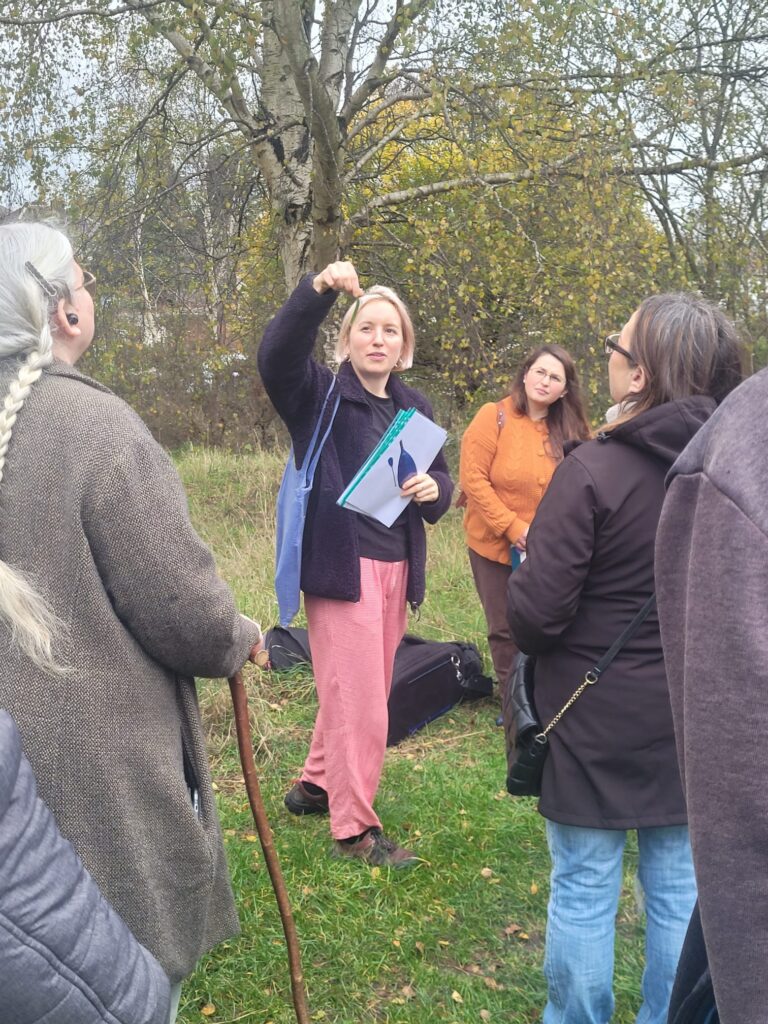 Katy leading the Tree Walk in Hodge Hill, leading up to Tree Week planting - she identifies a hornbeam leaf by the fact they look like McCoy's!