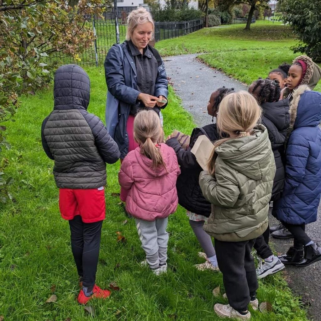 Katy talking to children on the Tree Walk, teaching them about local trees