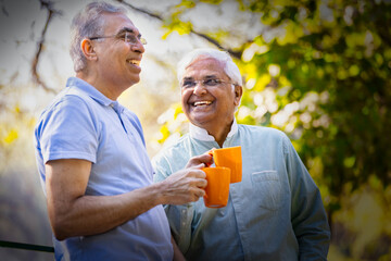 Two men talking, trees behind them, tree talk, holding mugs