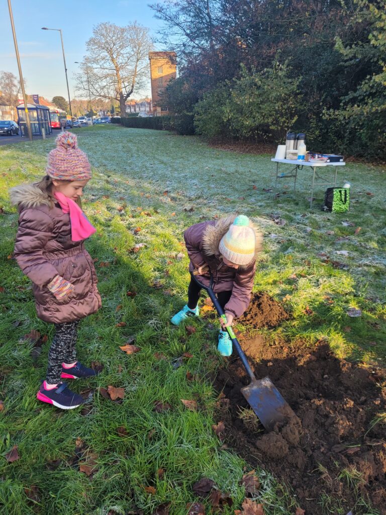Two young ladies digging the hole in Hodge Hill