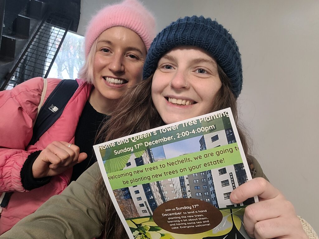 Katy and Charley with the Sunday 17th Dec Home and Queens Towers planting flyer, inside the blocks.